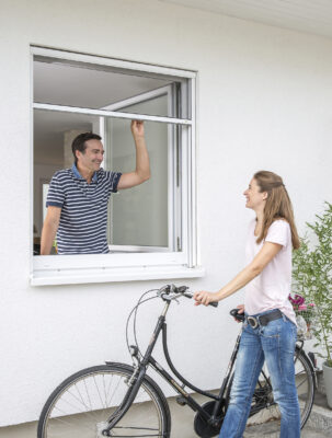 Insektenschutzrahmen am Fenster eines modernen Hauses – Interaktion zwischen innen und außen.